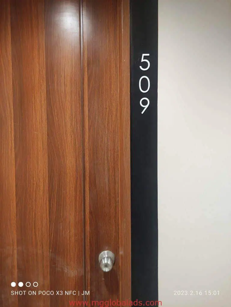 Black acrylic room signage panel 509 beside wooden door in Makati office setting by M&G Global Ads.