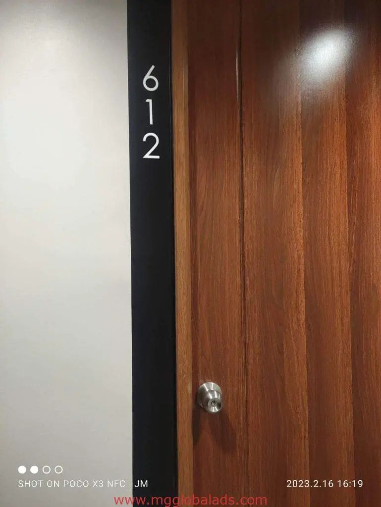 Room number 612 indoor signage on white and black wall near wooden door in Makati, by M&G Global Ads.