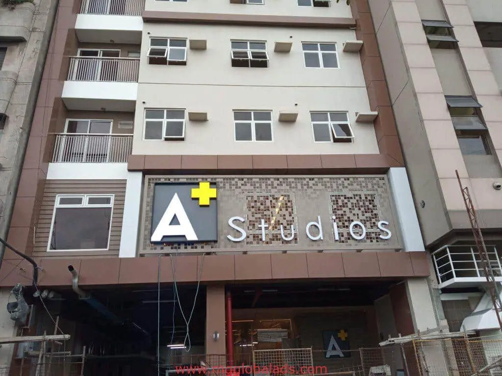 LED signage for A+ Studios on a modern building facade in Ortigas with windows and balconies by M&G Global Ads.