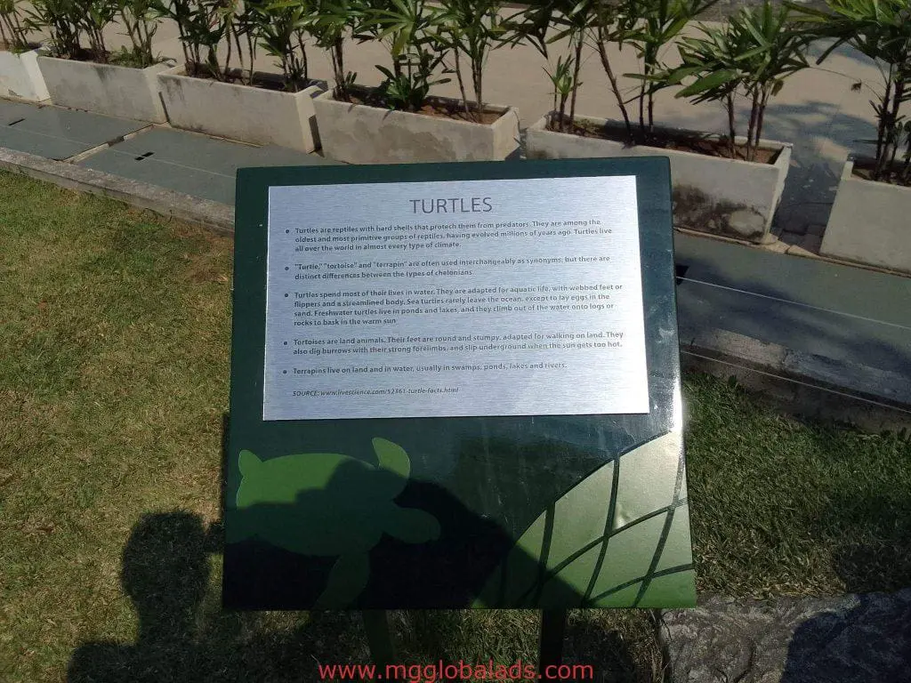 Outdoor educational turtle metal signage display in Quezon City with info text, among plants, by M&G Global Ads.