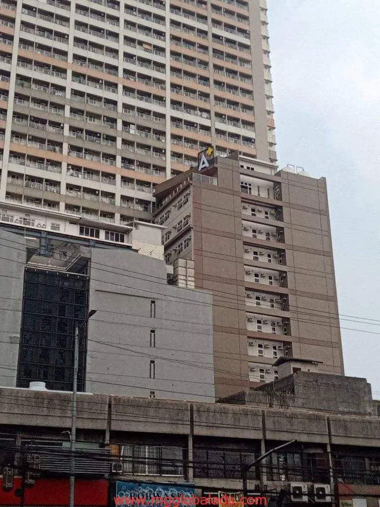 Apartment building with custom outdoor letter A signage in Makati, residential area, cloudy sky—by M&G Global Ads.