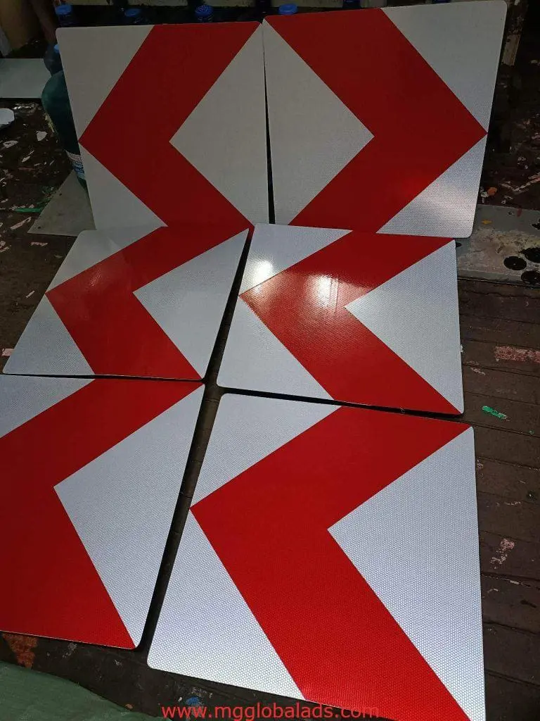 Chevron metal directional indoor signage for Makati, three point left and two right on wood floor, by M&G Global Ads.