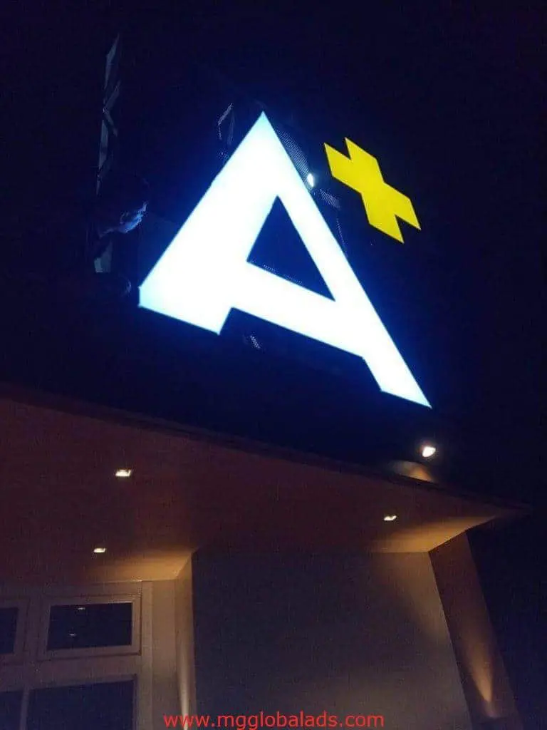 LED building signage with a white letter A and yellow plus, night view in Makati, by M&G Global Ads.