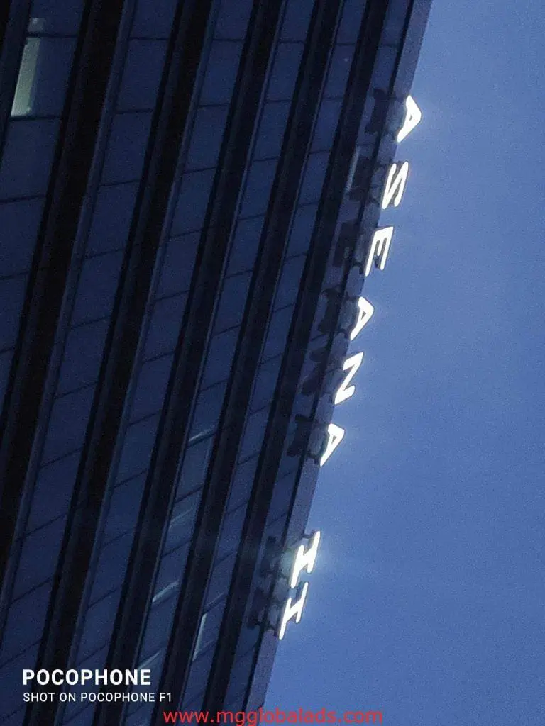 Vertical LED signage for ASEANA II on a glass building in BGC, Metro Manila by M&G Global Ads.