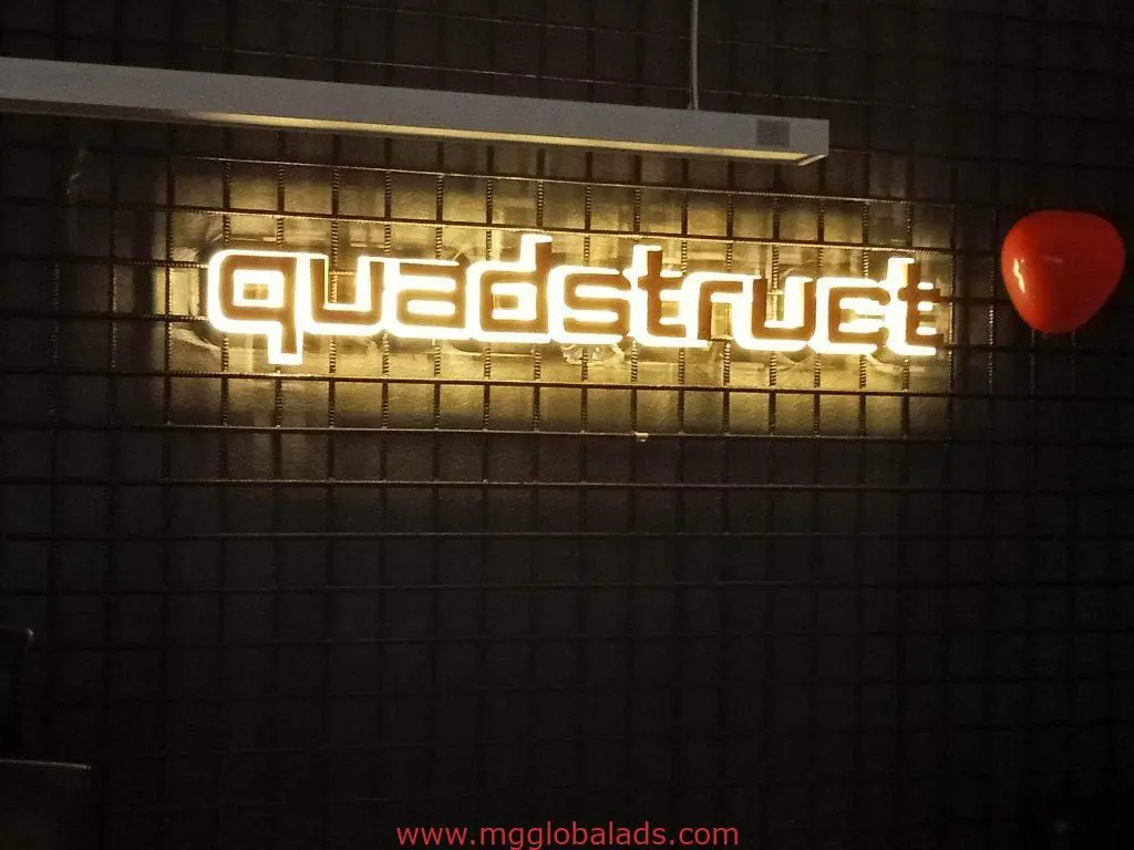 LED signage in Mandaluyong displays quadstrut on dark, textured wall with red balloon. LED signs by M&G Global Ads.