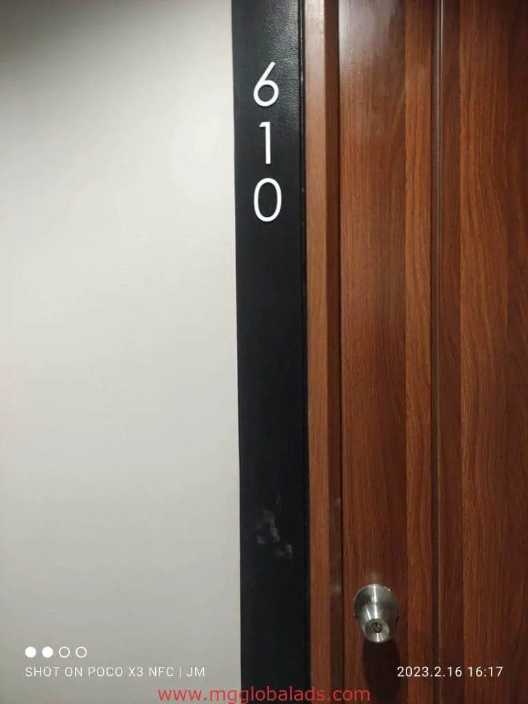 Building signage panel displaying 610 beside a wooden door, Quezon City project by M&G Global Ads.