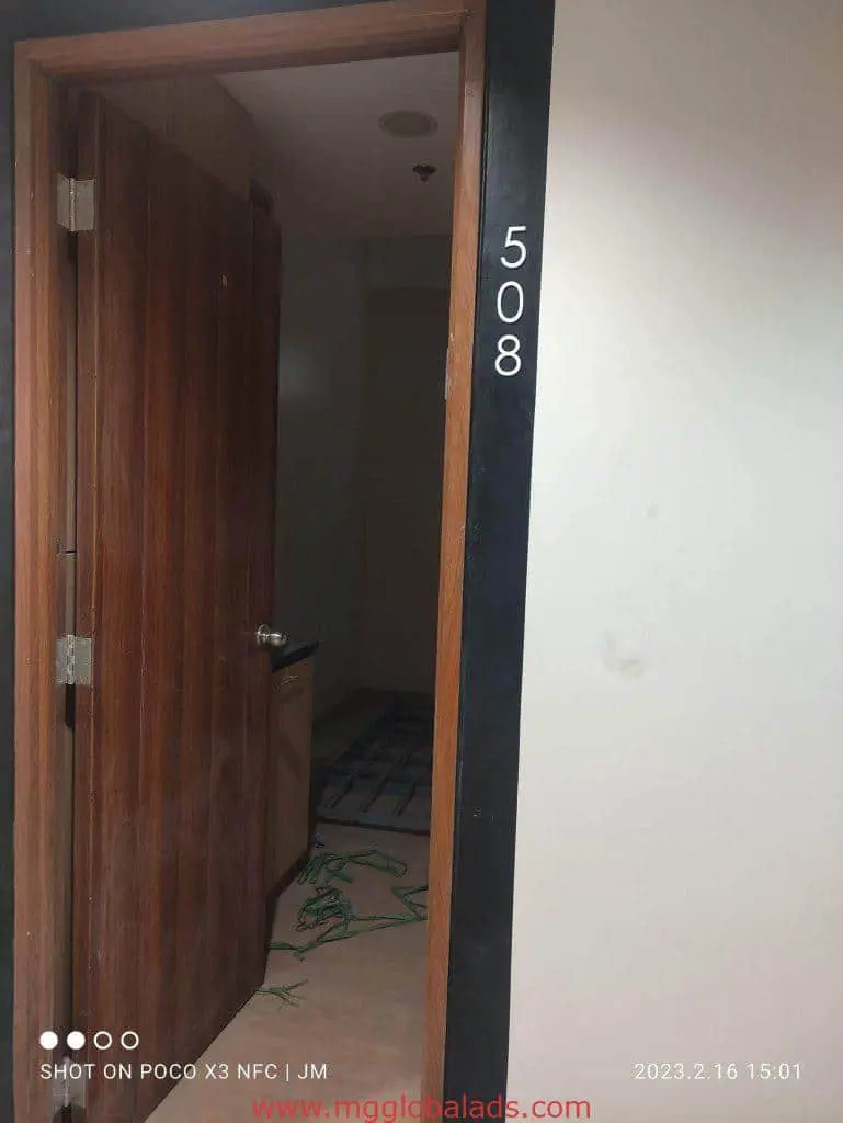 Room signage for door 508 with building signage, Makati—partially open, bed visible. Photo by M&G Global Ads.