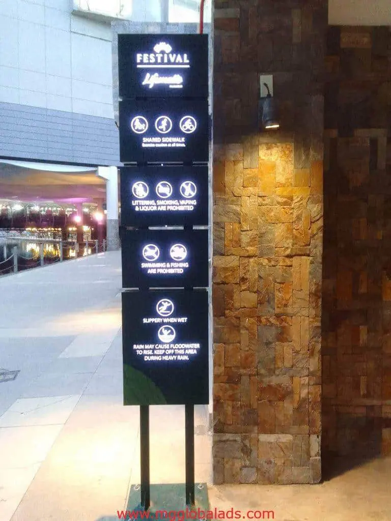 Building signage at shopping area in Makati listing rules and safety tips; vertical sign by M&G Global Ads.