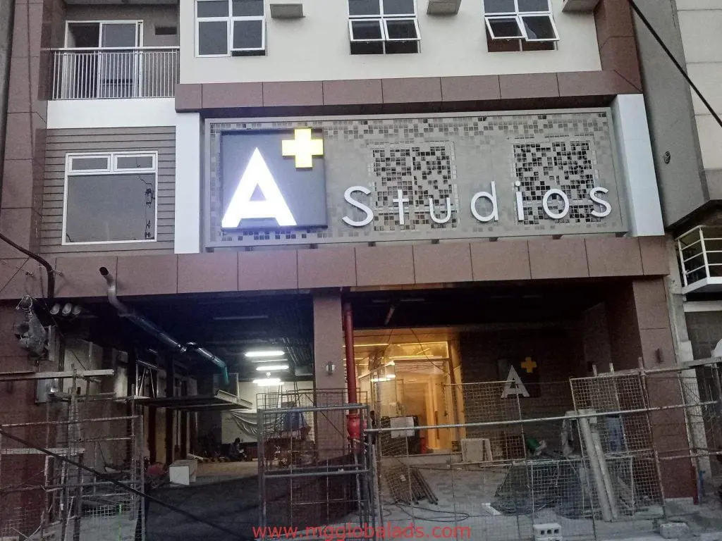 Illuminated outdoor signage for A+ Studios on a construction site in Makati, by M&G Global Ads.