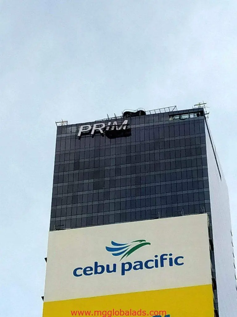 Building signage PRIM and Cebu Pacific billboard in Ortigas, featuring brand logo, by M&G Global Ads.