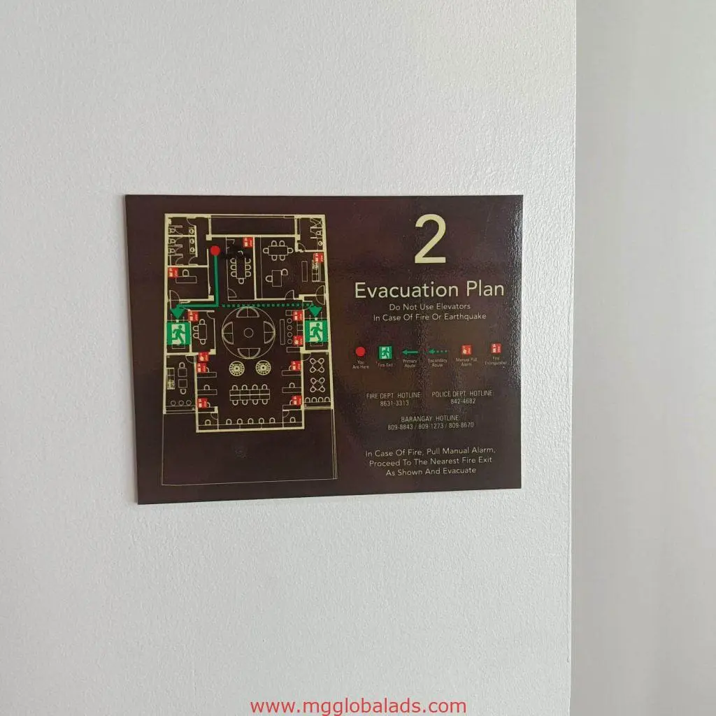 Evacuation plan building signage in Makati showing 2nd-floor exits, stairs, and fire safety info by M&G Global Ads.