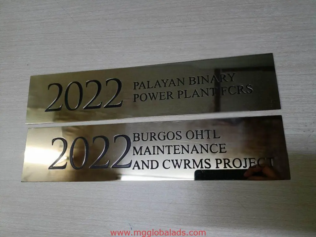 brass engrave project signage for PALAYAN BINARY POWER PLANT & BURGOS OHL, shown on a light surface in Mandaluyong by M&G Global Ads.