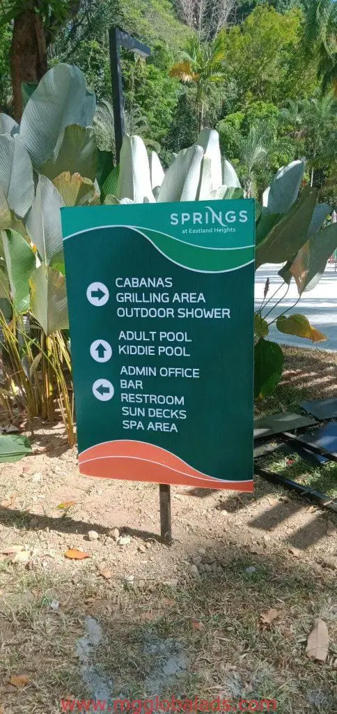 Green directional outdoor signage for Springs, Eastland Heights in Quezon City by M&G Global Ads.