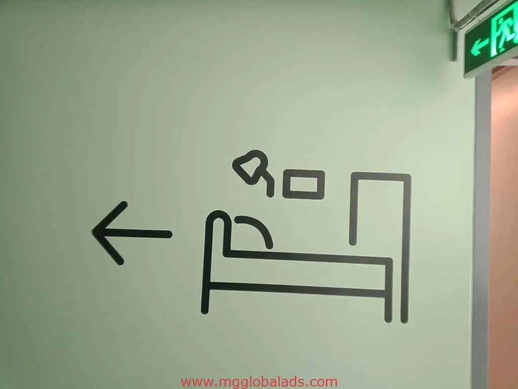 Hospital wayfinding indoor signage for patient rooms, Quezon City, wall-mounted with icons and arrow by M&G Global Ads.