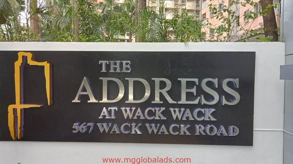 Acrylic outdoor signage for The Address at Wack Wack in Mandaluyong, bold grey and gold text on black by M&G Global Ads.