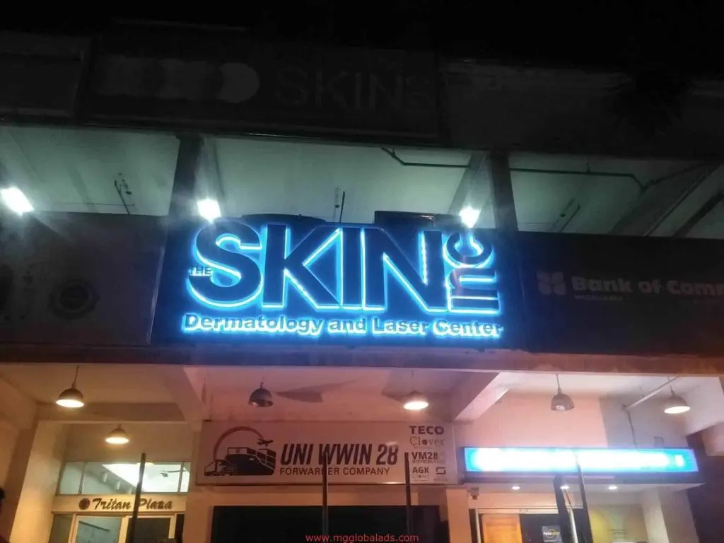 Storefront signage for THE SKIN inc Dermatology and Laser Center in blue and white, night view in Makati by M&G Global Ads.