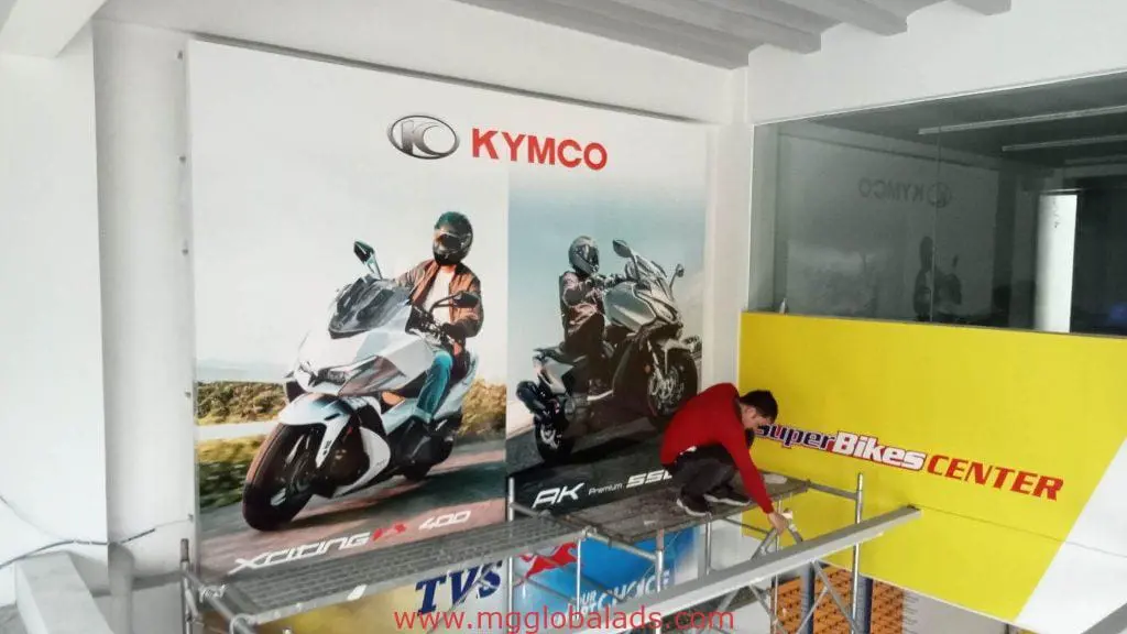 SuperBikes CENTER building signage installation for KYMCO in Makati, featuring large scooter posters, by M&G Global Ads.