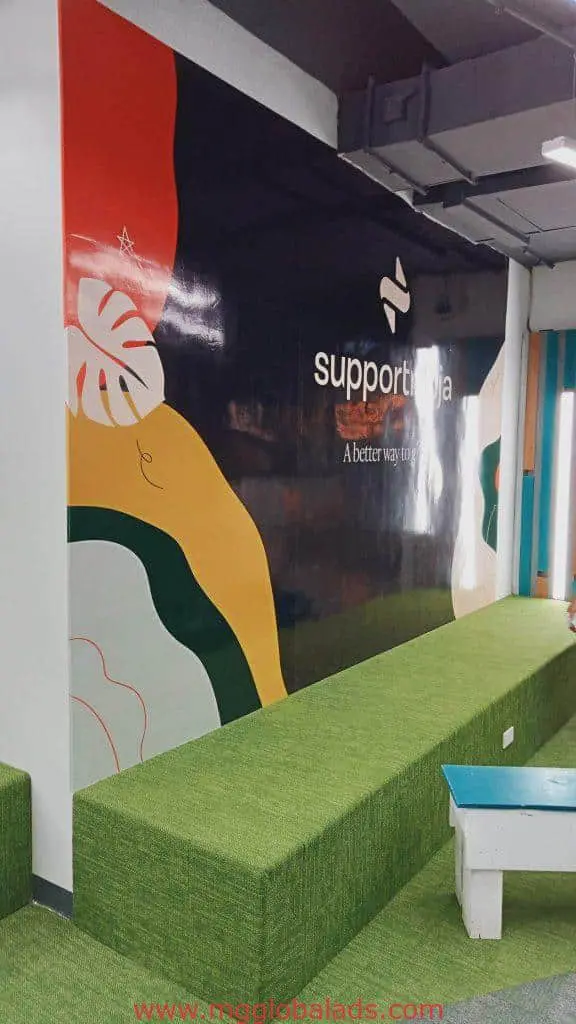 Indoor signage for SupportNinja office lounge in BGC, modern seating and mural on black wall by M&G Global Ads.