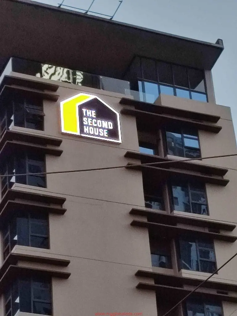 Outdoor building signage for The Second House in Makati with black and yellow house-shaped frame by M&G Global Ads.