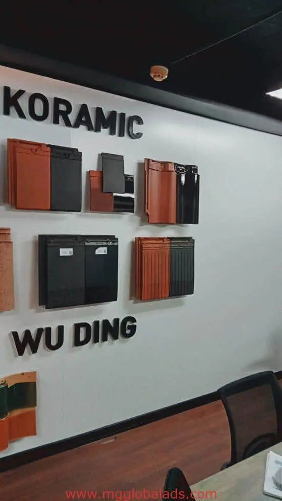 Indoor showroom signage for KORAMIC and WU DING roof tiles in Makati, featuring sample wall by M&G Global Ads.