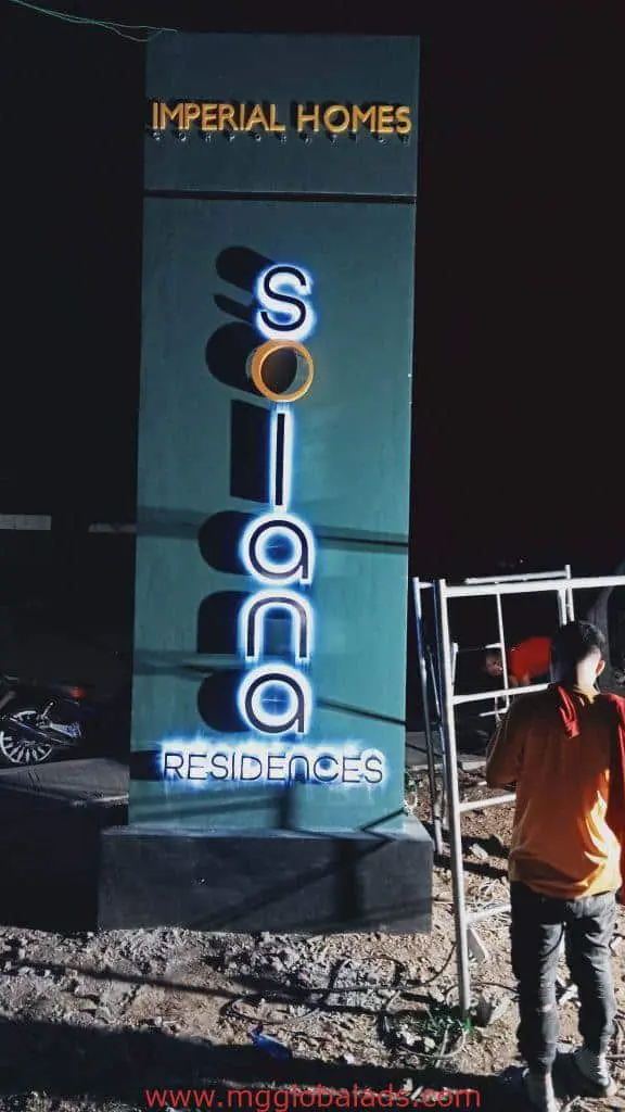 LED signage for Imperial Homes Solana Residences, night view in Quezon City, person nearby, by M&G Global Ads.