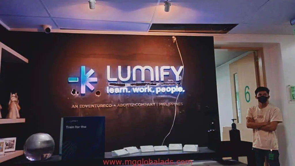 LUMIFY indoor LED signage in reception area, Quezon City, by M&G Global Ads. Man in mask near door 6, items on counter.