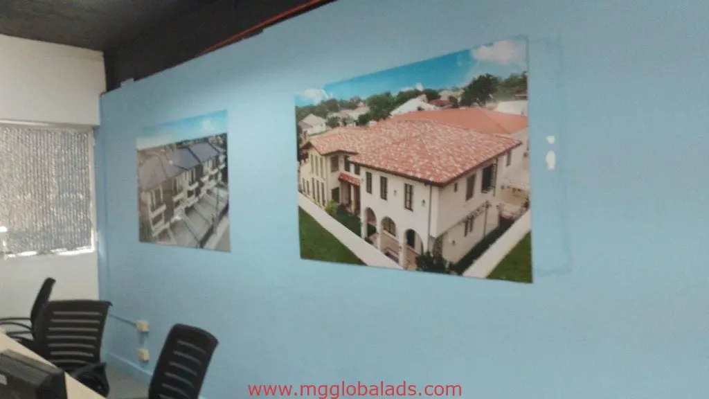 Sleek metallic office signage above desks in Makati with house photos, contemporary decor by M&G Global Ads.