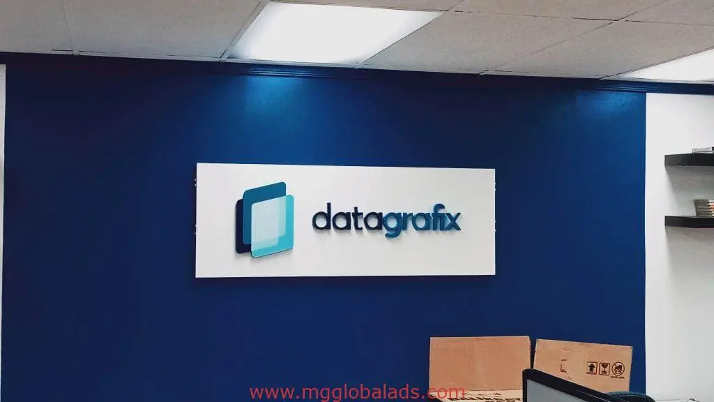 Datagrafix metallic office wall signage in Makati, featuring blue and teal logo above boxes by M&G Global Ads.