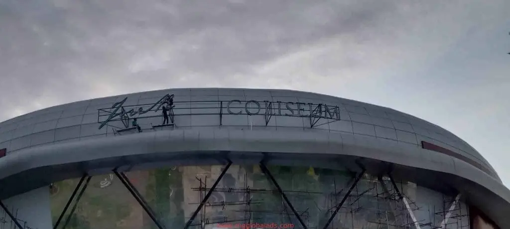 Outdoor LED acrylic signage installation for COLISEUM on a curved facade in Quezon City, by M&G Global Ads.