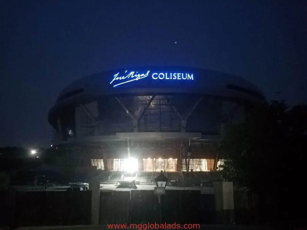 Illuminated metallic Jose Nigri Coliseum signage and LED display on round building at night in Ortigas by M&G Global Ads.