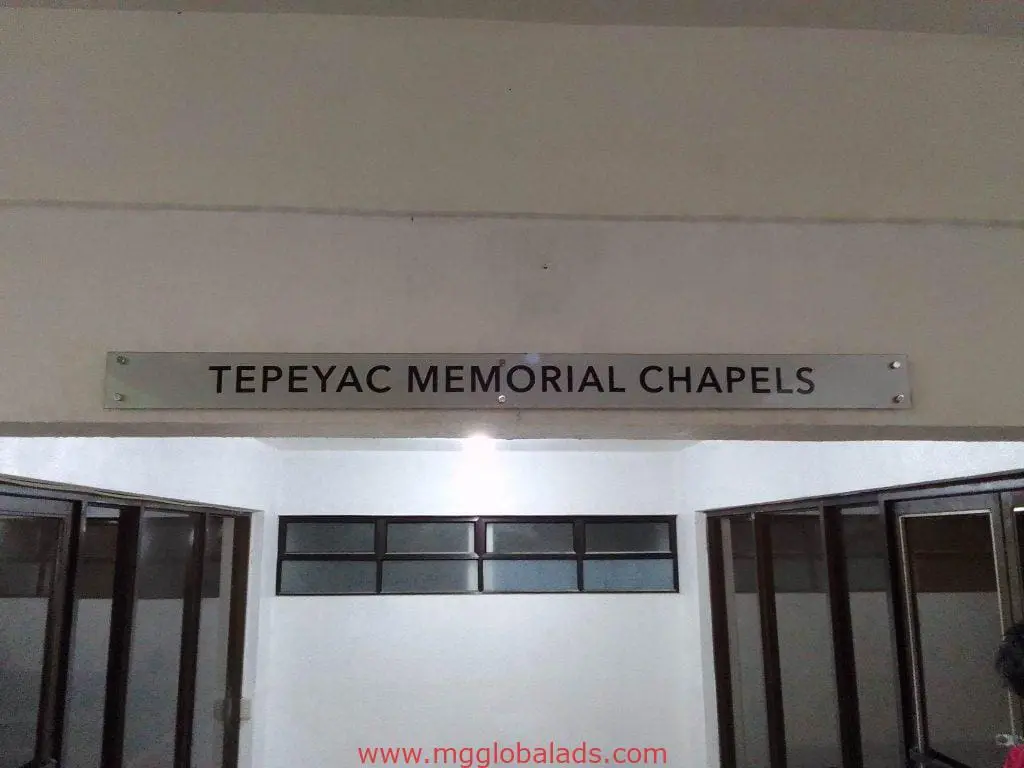 Indoor signage for Tepeyac Memorial Chapels on a white wall in Quezon City by M&G Global Ads.