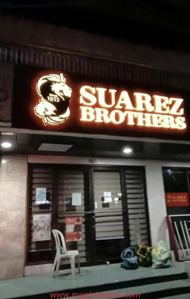 Metallic Suarez Brothers signage with horse logo above closed store in Makati, store no.105, by M&G Global Ads.