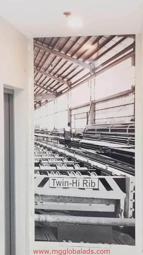 Industrial warehouse with metal beams, machinery, metallic signage Twin-Hi Rib in Mandaluyong by M&G Global Ads.