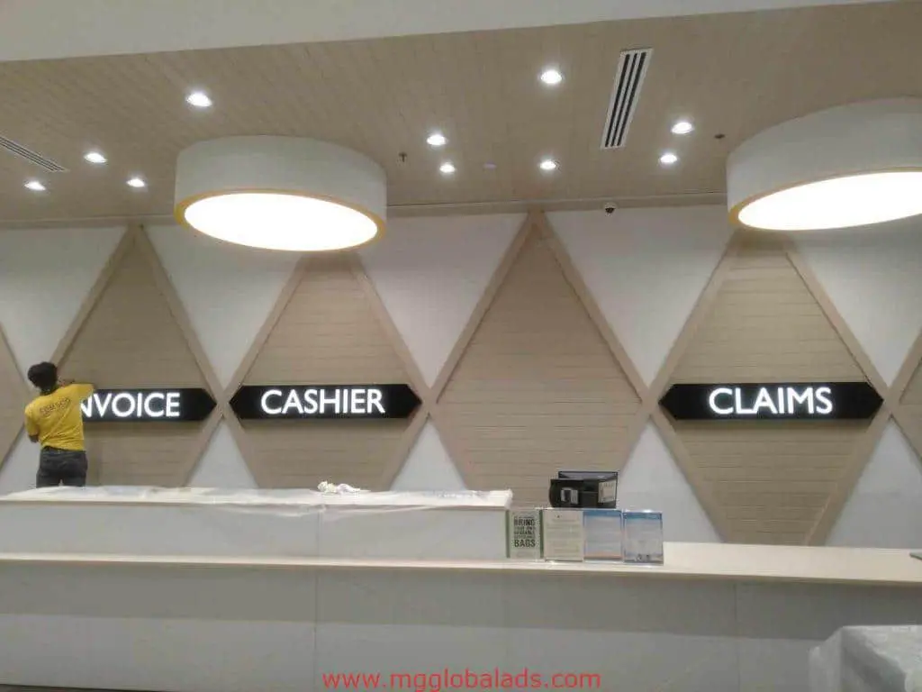 Illuminated acrylic INVOICE, CASHIER, CLAIMS signage in office counter area, Quezon City. By M&G Global Ads.