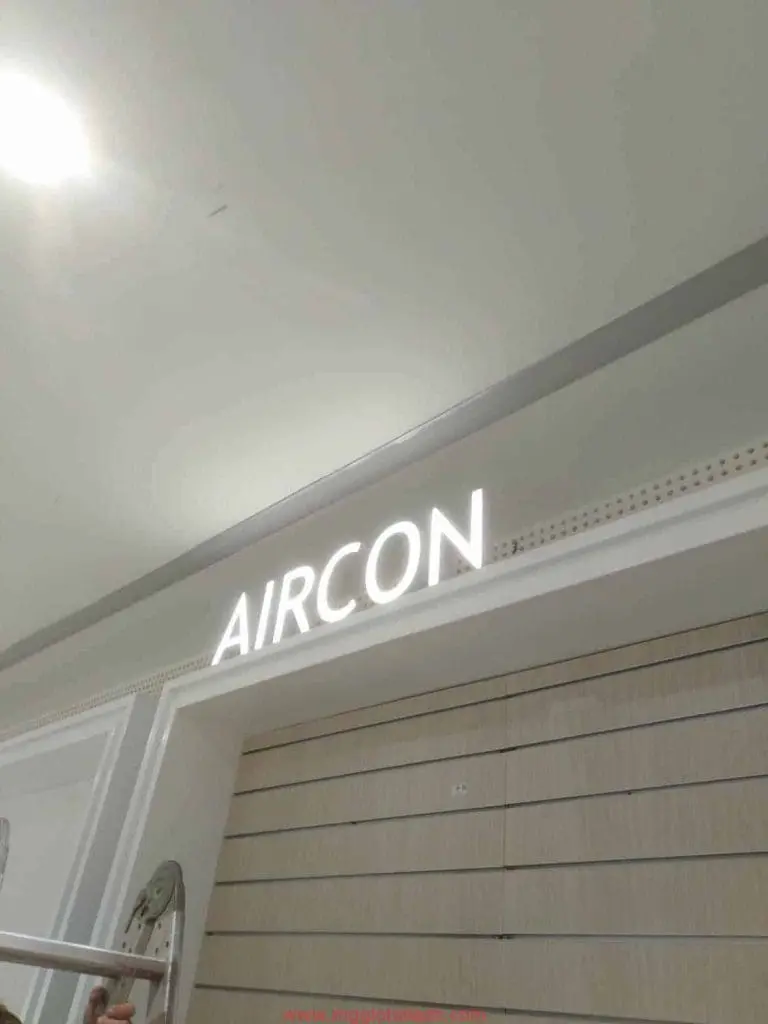White LED signage AIRCON on a light slatted wall in a modern office, Makati. Indoor LED sign by M&G Global Ads.