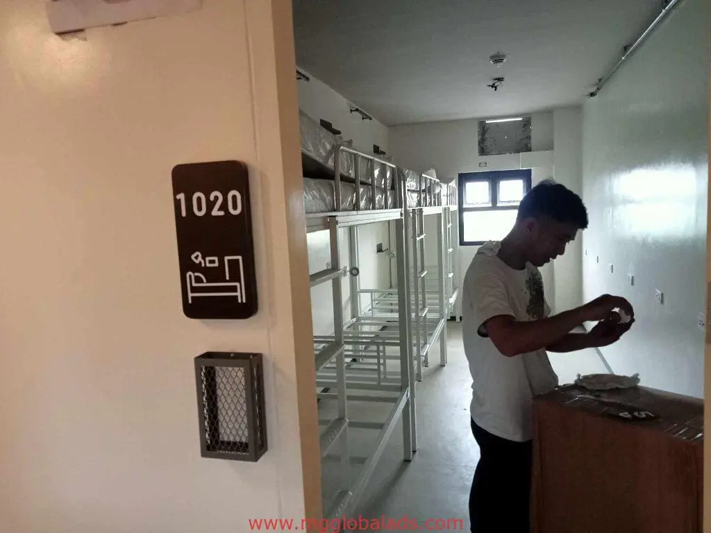 Clear acrylic room signage 1020 in a dormitory in Makati, with bunk beds and bright window light, by M&G Global Ads.