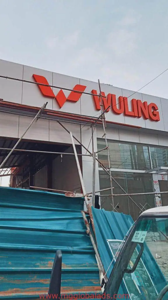 LED signage display for WULING with red logo on building facade under construction in Ortigas by M&G Global Ads.