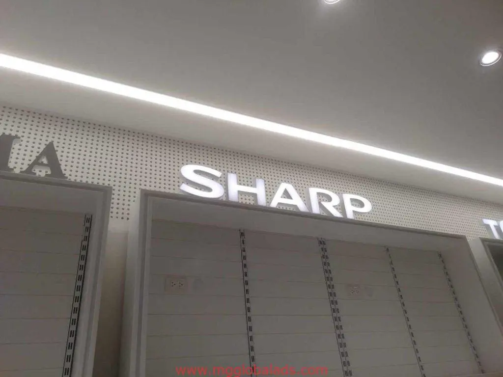 SHARP LED signage display with white shelves in a well-lit store, empty below, in Makati by M&G Global Ads.