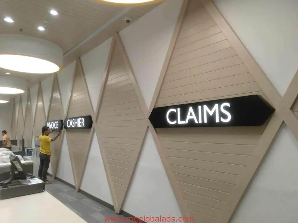 Acrylic office signage installation for cashier and claims in Mandaluyong with illuminated letters by M&G Global Ads.