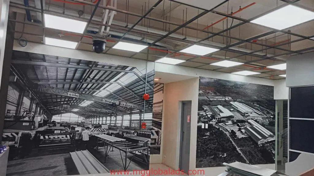 Acrylic signage and black-and-white murals in a modern Mandaluyong office interior by M&G Global Ads.