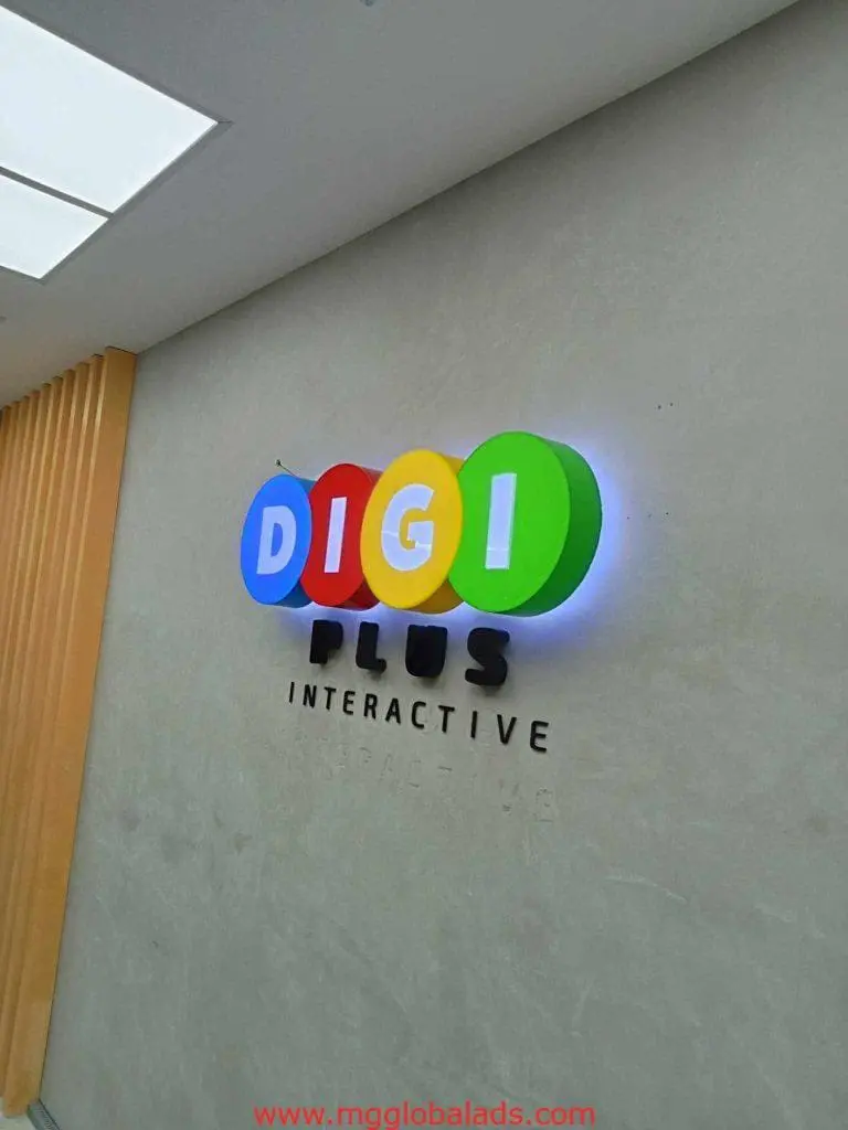 Illuminated metallic signage for DIGI PLUS INTERACTIVE in Makati, multi-color LED letters on gray by M&G Global Ads.