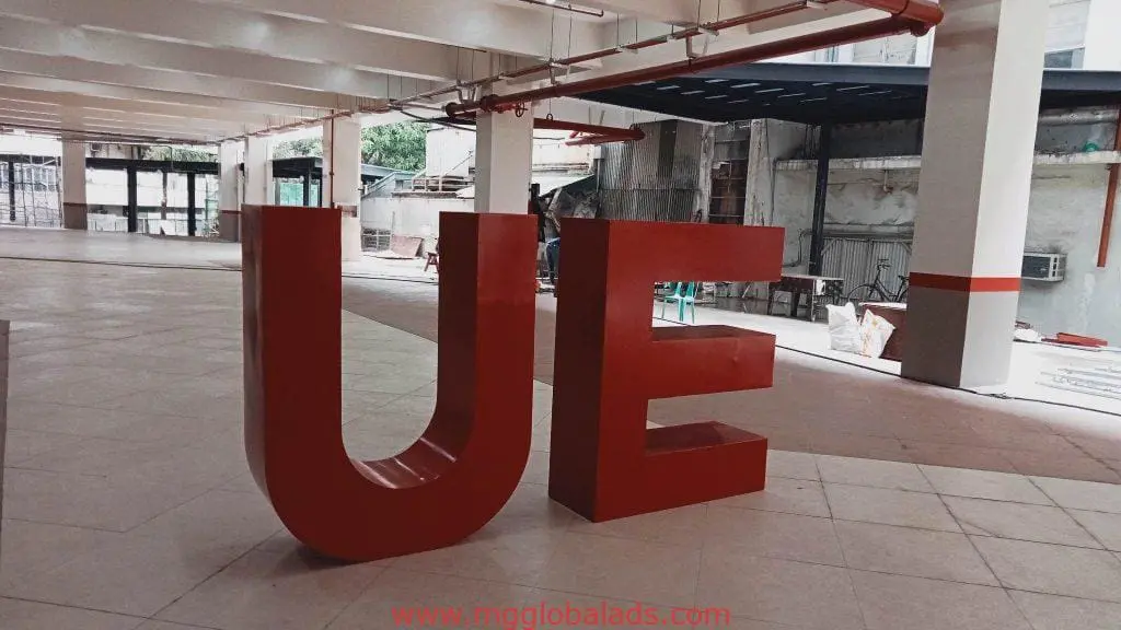Building signage for UE: large red 3D letters stand in an indoor space, Ortigas branch, by M&G Global Ads.