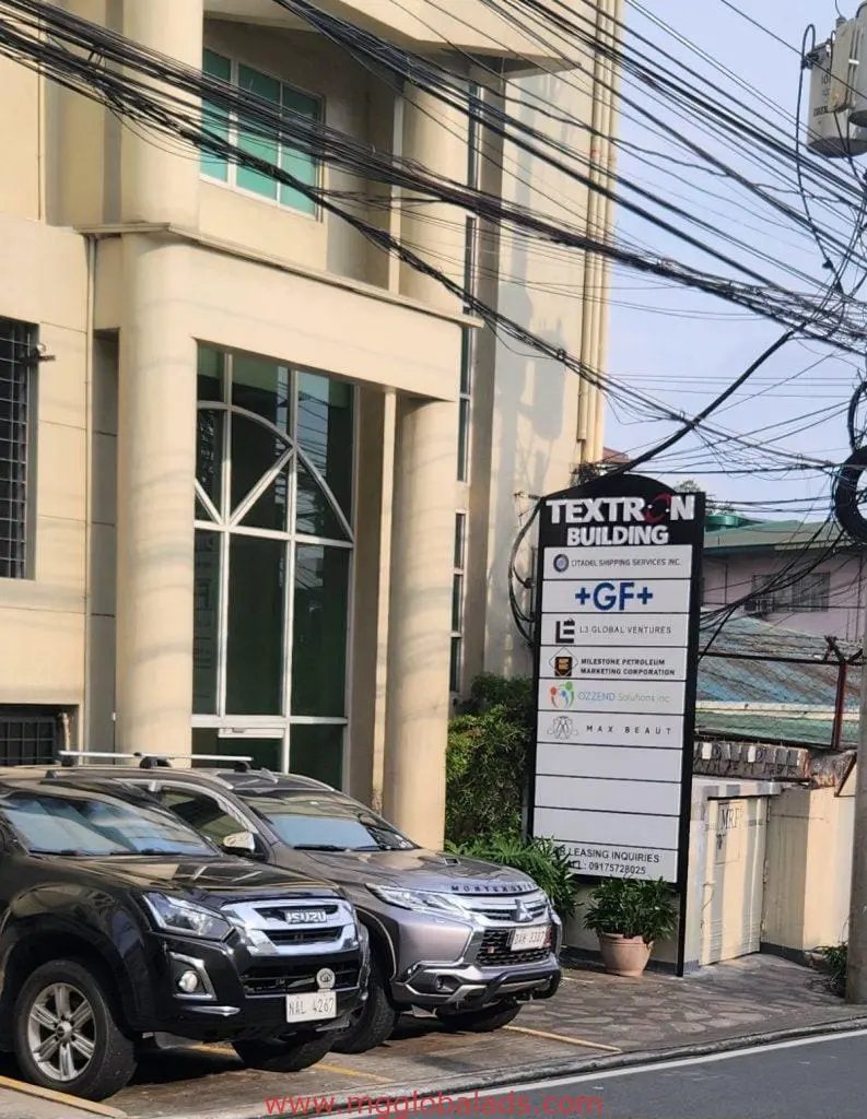 Metal signage for TEXTRON BUILDING and companies in front of beige office in Ortigas, Metro Manila by M&G Global Ads.
