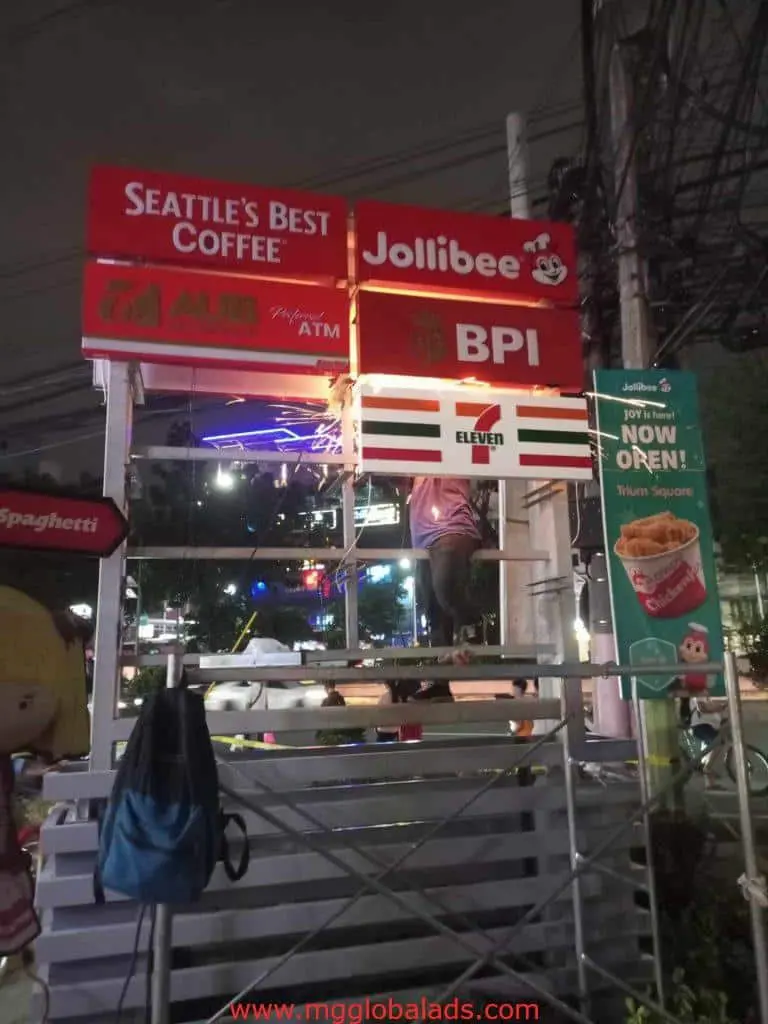 Outdoor LED signage for Seattles Best Coffee, Jollibee, BPI, AUB & 7-Eleven in Quezon City at night by M&G Global Ads.