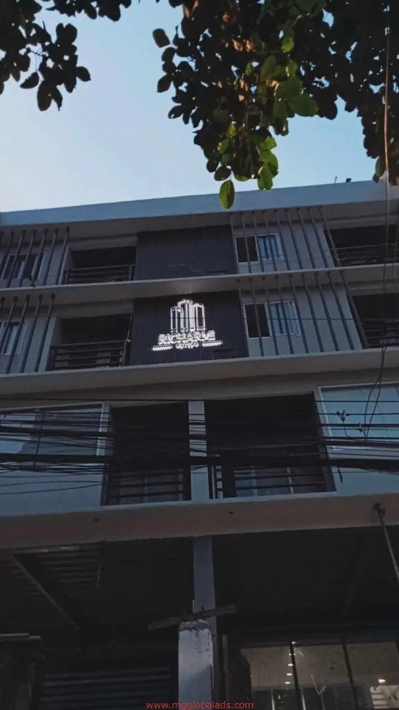 Metallic SKYLINE Executive Suites signage on a multi-story building in Makati at dusk, by M&G Global Ads.