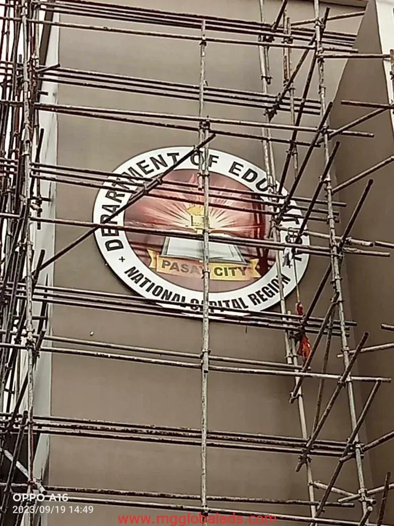 Round metallic Department of Education signage with scaffolding in Quezon City, client: DepEd. By M&G Global Ads.