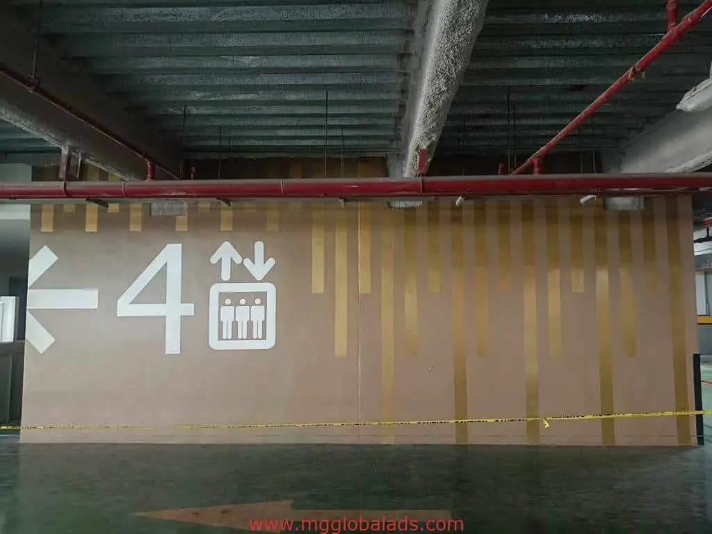 Indoor parking garage signage with number 4, elevator icon, and arrow in Makati by M&G Global Ads.
