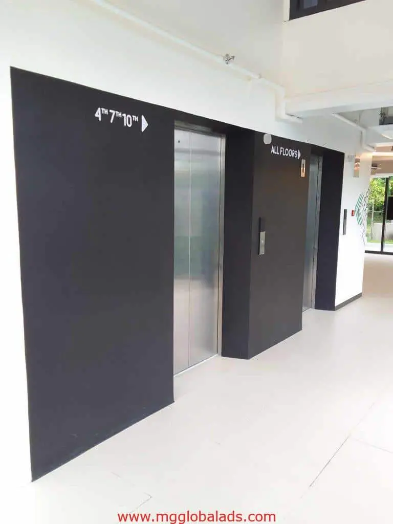 Elevator LED signage with floor numbers and arrows in a modern Mandaluyong building by M&G Global Ads.
