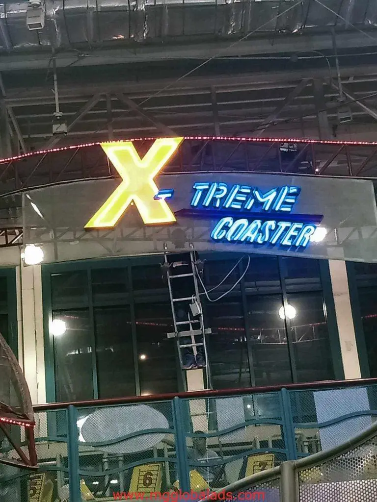 LED neon signage for Xtreme Coaster with yellow X, blue letters at amusement park in Quezon City, by M&G Global Ads.