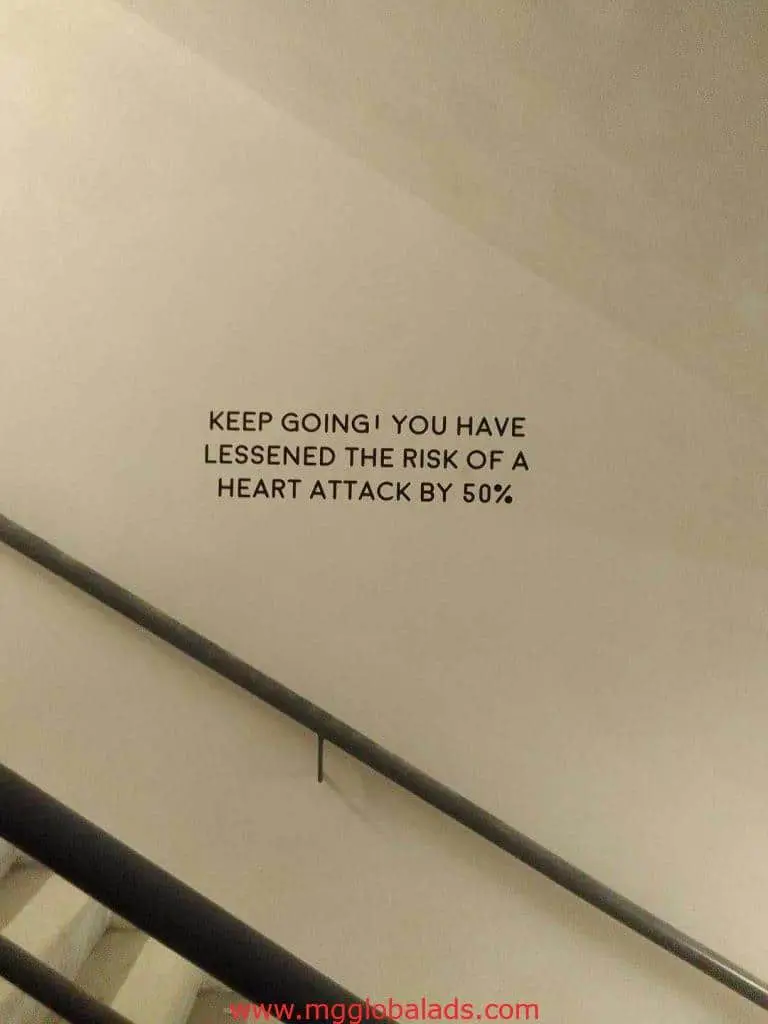 Acrylic stairwell signage in Quezon City reads KEEP GOING, inspiring heart health by M&G Global Ads.